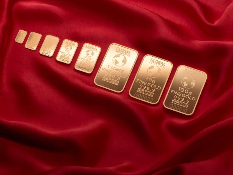 Gold bars displayed on red fabric