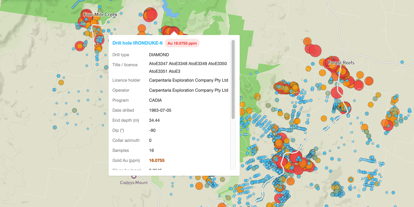 Dig Here map with thousands of colour-graded drill assay results and an open popup showing a 16 g/t gold intercept